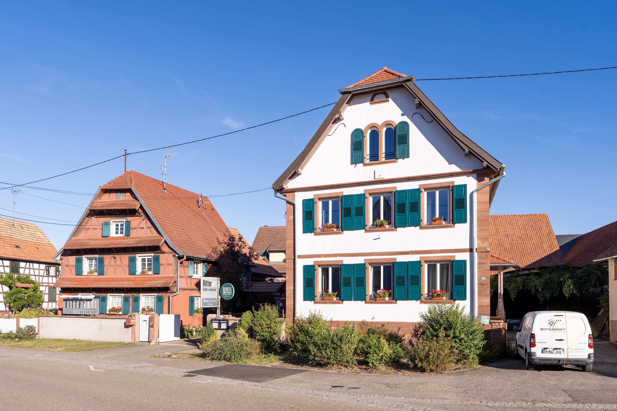 Alsatian hotel façade with green shutters