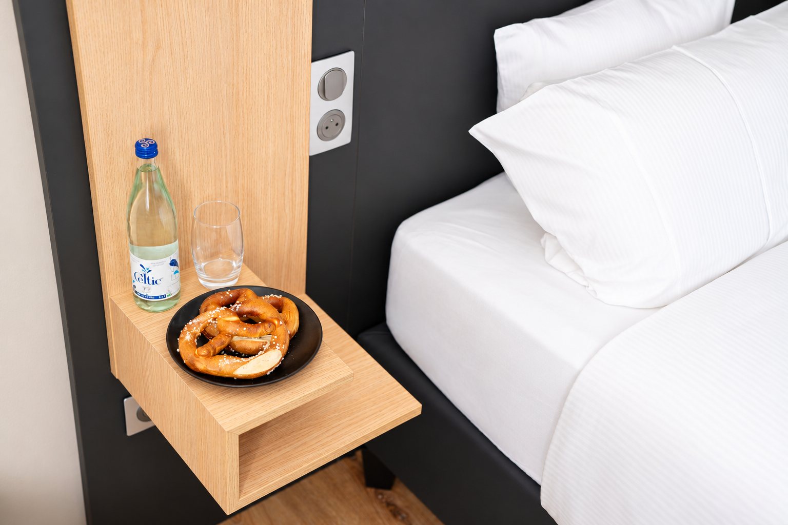 Pretzel and water on the bedside table